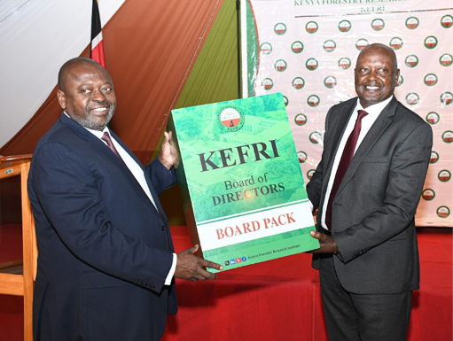 Gen (Rtd) Samson Mwathethe (left) handing over the Board Pack to Lt Gen (Rtd) Walter Koipaton